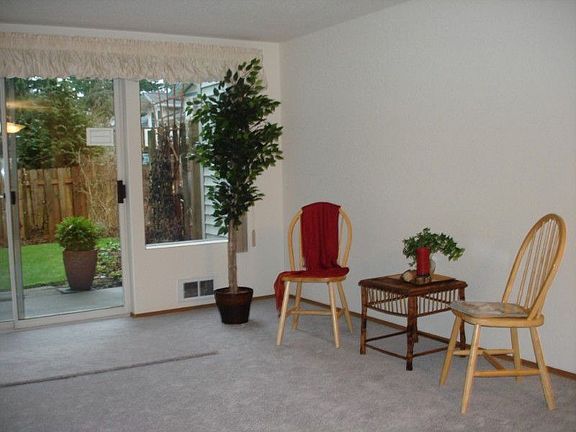 Living room w/slider door provides view of peaceful garden & patio