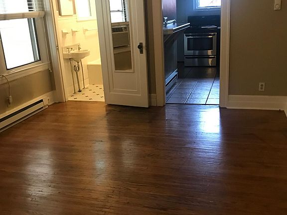 Bedroom showing bathroom and kitchen