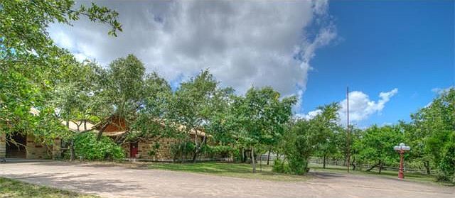 Attractive stone home with metal roof on spacious 1.48 acre home site.