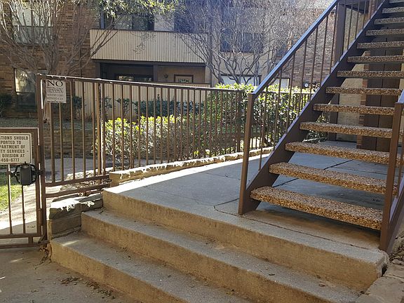 Steps leading to your new home and thru the gate is BBQ area and tennis courts, etc.