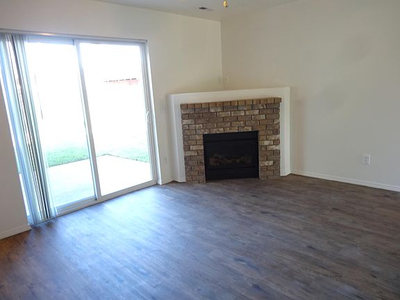 beautiful chocolate brick electric fireplace and vinyl plank flooring