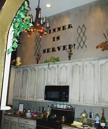 Kitchen has granite, two chandeliers and 14' ceilings