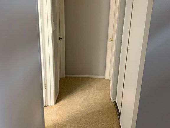 Hallway to bedrooms. With hallway linen closet