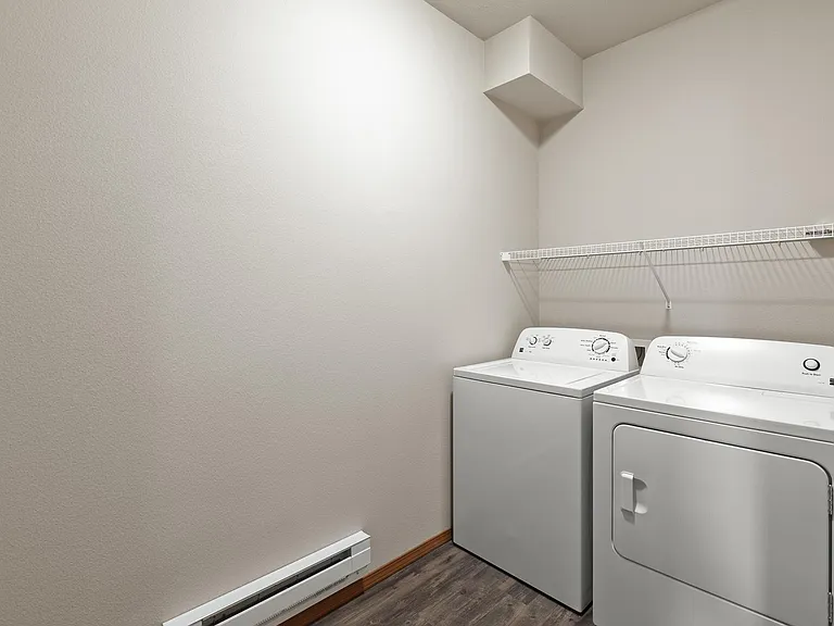 Full sizes washer and dryer and plenty of room in laundry room for laundry hampers.