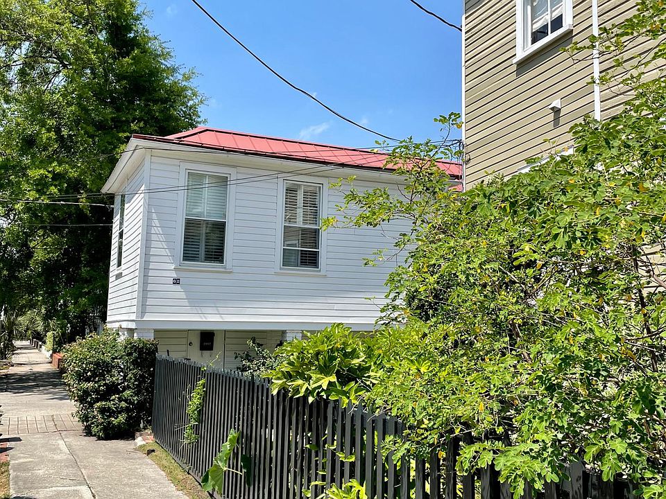 Street view of unit (upstairs, white building, red roof)