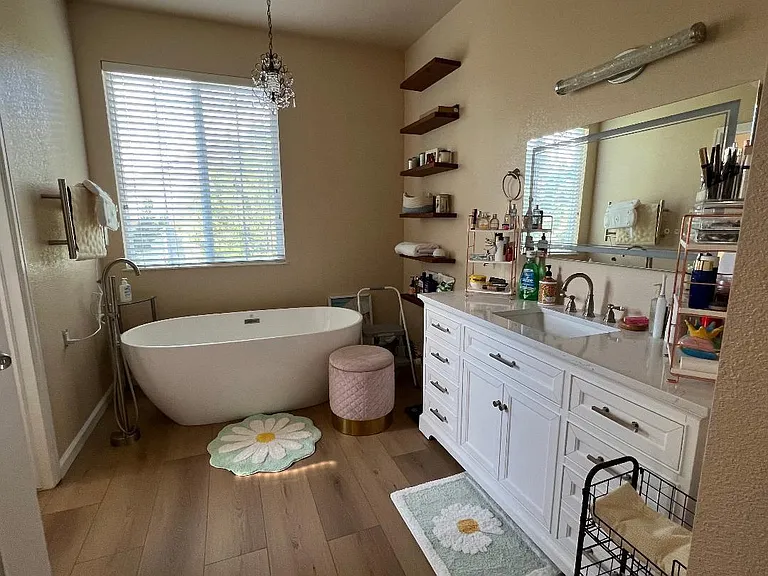 Master bathroom with a large soaking tub and heated towel rack