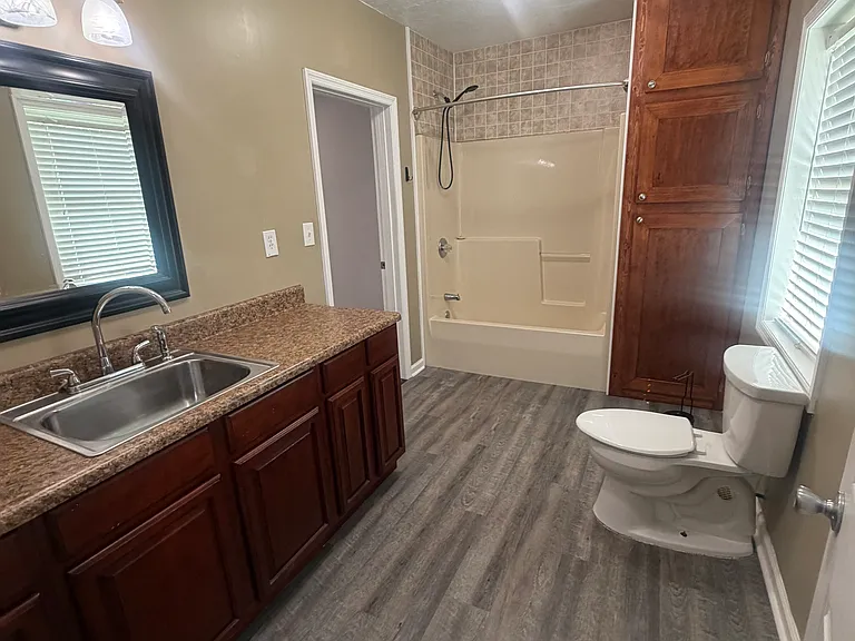 Shared bathroom, large with ample counter space & storage.
