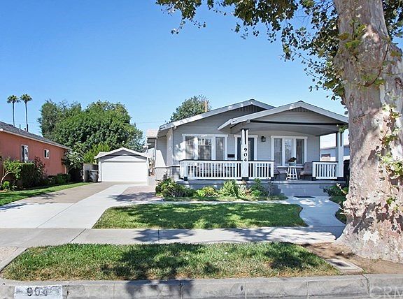 Beautiful California Bungalow on a tree lined street, long driveway to the two car garage.