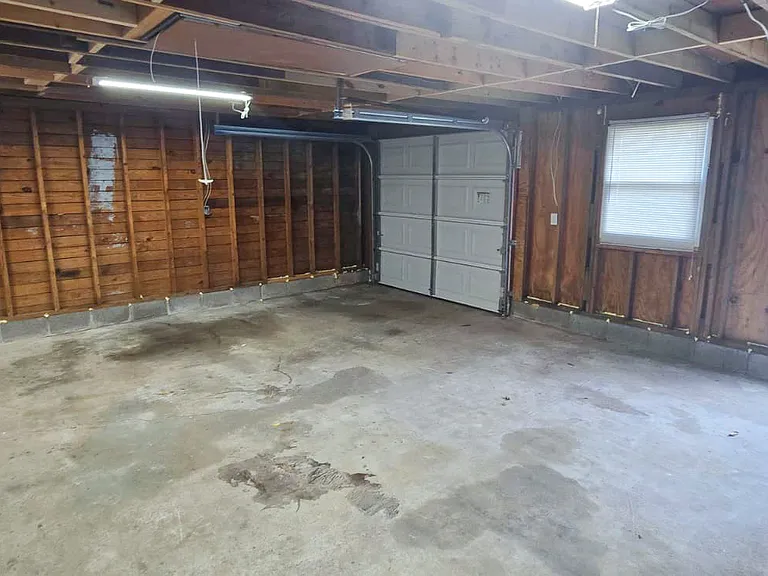 very spacious garage with shop tables built in