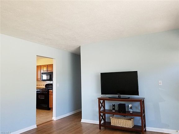 Living room side wall and view into kitchen