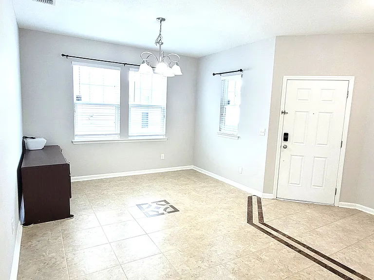 First floor Entrance- Main Entry door on the left and Garage Door Entry on the right. This is an official Dining room per plan, but can be used as Front Office or Sit out room.