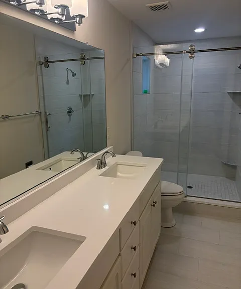 new bathroom tile and enclosure, new light fixtures, new shower door.