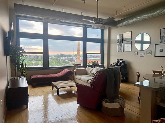 Living room with lots of natural light and custom high-end blinds. New windows installed in 2018!