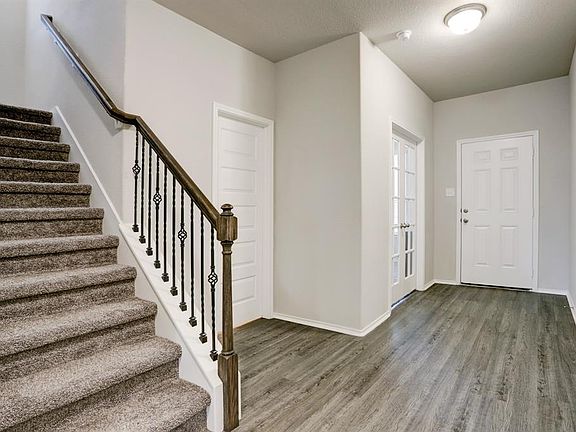 At the front of the home is the study with glass French doors. This room also has a large closet and is currently being used as a 5th bedroom. There a powder room next to the study and floors are luxury vinyl planked wood in a great neutral color. Wr