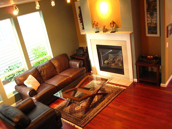 Family room with fireplace adjacent to kitchen and half bath