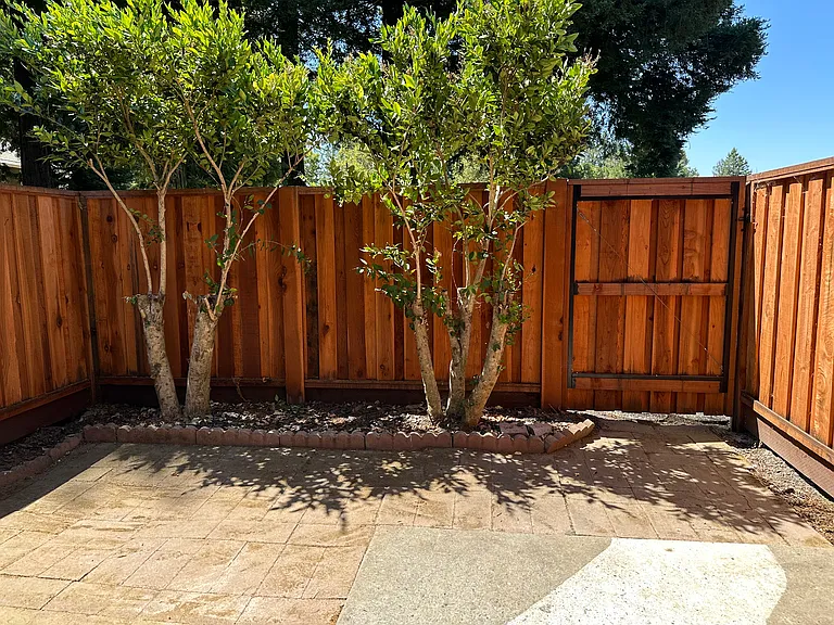 Exterior patio with gate to common area and pathways along the golf course