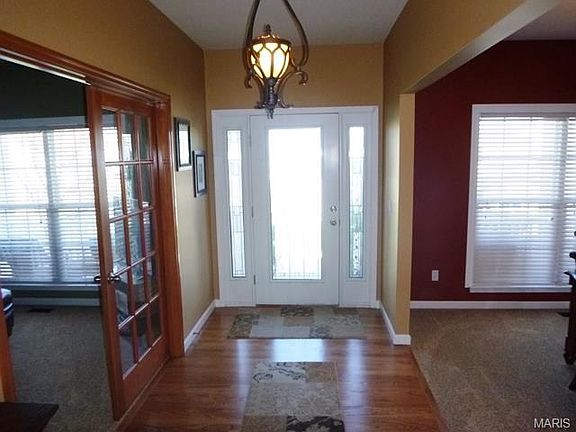 Entry Foyer with Wood Flooring and Oil Rubbed Bronze Chandelier