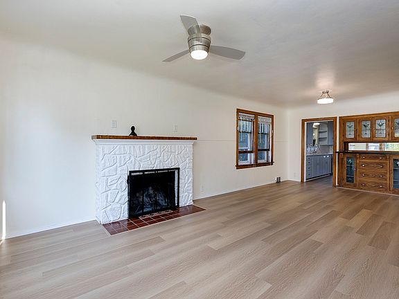 Living/dining room, ornamental fireplace and built-in antique hutch