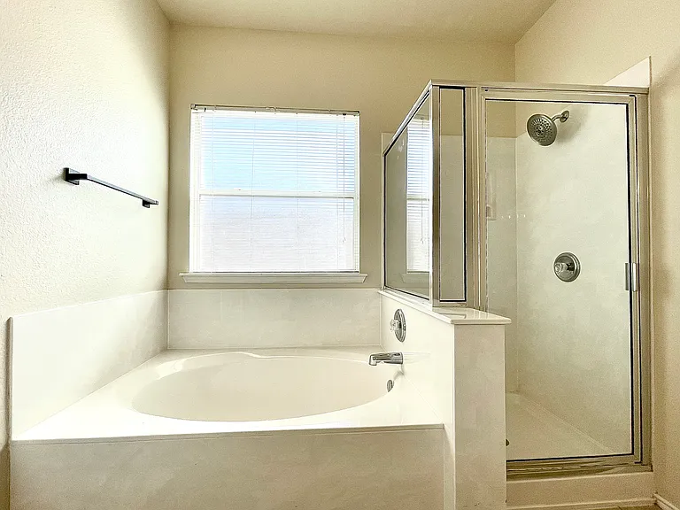 Master bathroom includes a garden tub and a shower