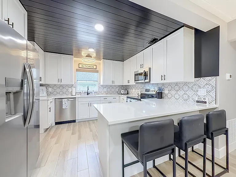 Have you ever been in a rental that has full sized appliances, room for three at the bar, wood ceilings and a view?!