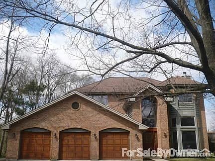 Front door/2 side lites 1/2 round window : Brick front, 3 1/2 car garage, 2 story front bay window, 