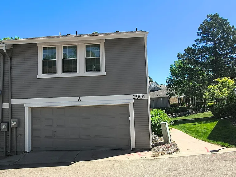 Backside View of 2 Car Garage and Upstairs Bedrooms