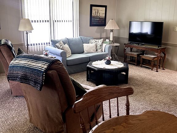Large family room with pull out couch and 2 lazy Boy recliners.
