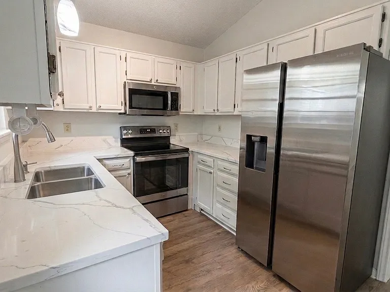Kitchen - featuring premium quartz countertops and stainless steel appliances