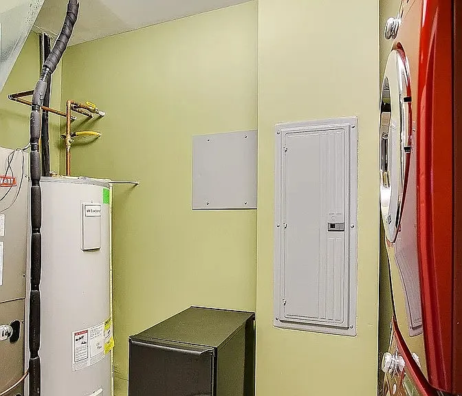 Utilities room with icemaker, washer dryer