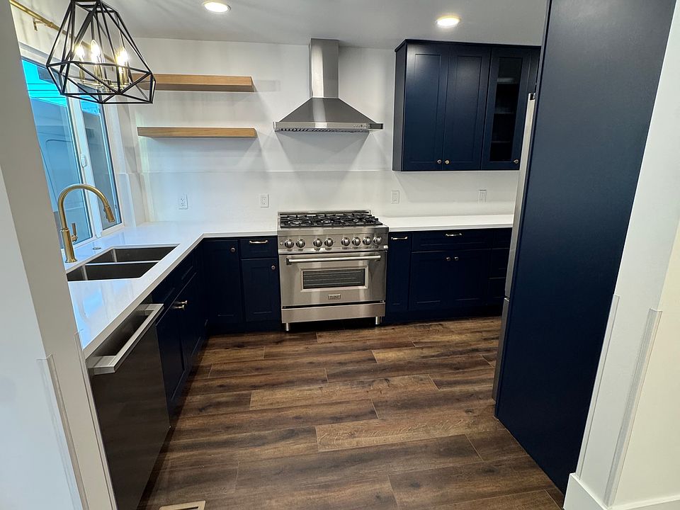 Navy Blue Cabinets with Gold/Black color scheme. New Appliances