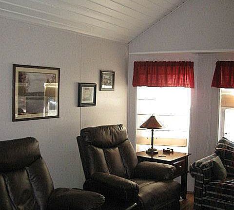 Living room features cathedral ceiling and big bay window to let in the light!