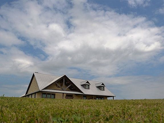 House sits on hilltop.