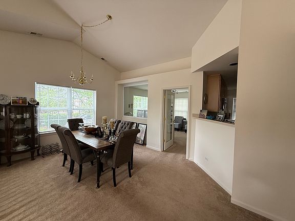 Elegant open-concept dining space perfectly situated for seamless entertaining, flowing effortlessly between the kitchen and main living areas.
