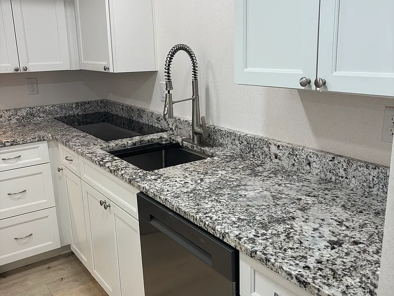 Kitchen View of Sink, Dishwasher & More Cabinets