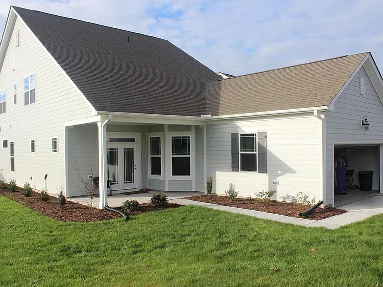 Back of the house - patio, lawn, garage & driveway.