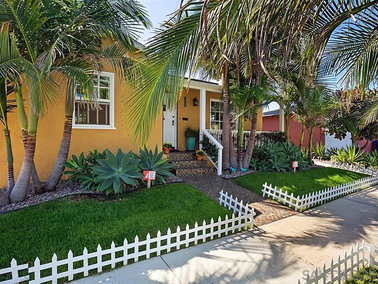 This image shows Part of the property that is visible from the Street Side. Entrance to the Apartment is located on the left side of the Picket Fence