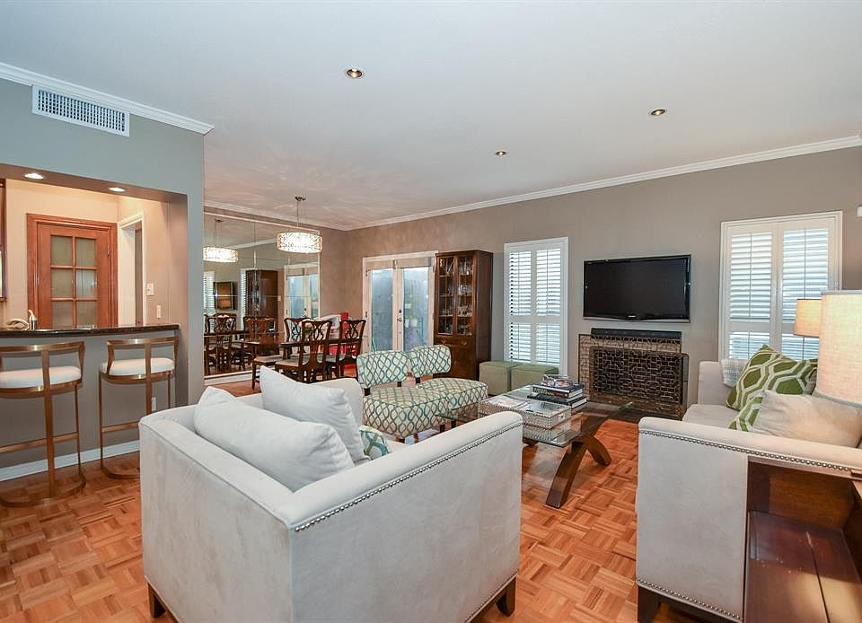 Fabulous open floor plan! Beautiful parque flooring throughout living and dining room. Crown molding graces the entire home as do Plantation shutters.