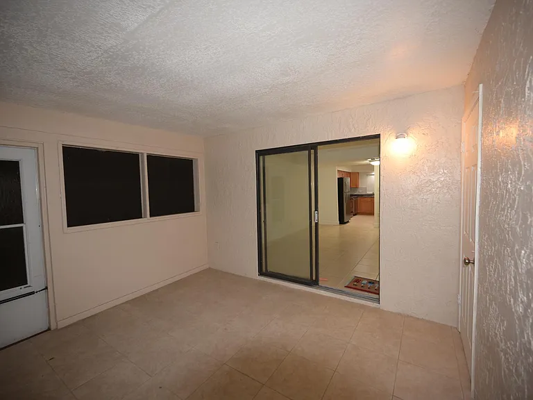 Screen porch looking into apt
