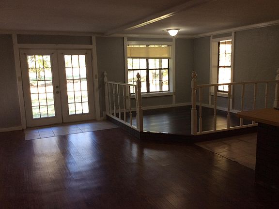 Living and dining area. French doors open to large front porch.