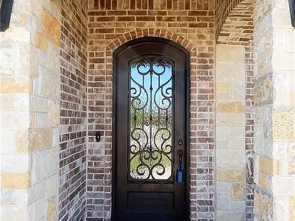 Beautiful iron door welcomes you as you approach this lovely home
