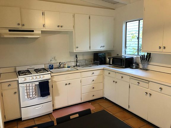 Eat in kitchen is spacious enough to have a dining table. It has a gas stove, full sized fridge, garbage disposal, plenty of cabinet space, tile floors and access to the deck.
