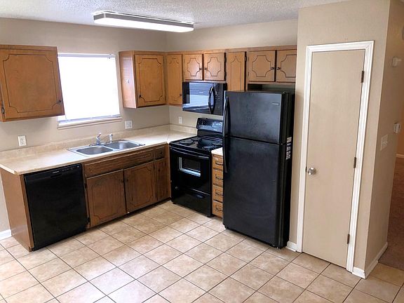 Kitchen, dishwasher, microwave, oven/range, fridge, pantry, tile flooring