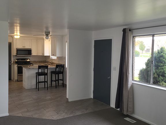 Living room looking into kitchen and dining area