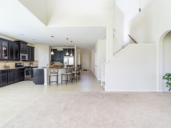 Beautiful ceramic tile flooring flows from the entry, front formal down the hallway into the kitchen and breakfast room, making it so easy to maintain!