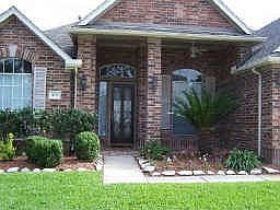 The front has a covered patio, nice leaded glass door and palladian windows.