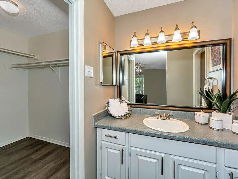 Bathroom with large mirror and bright vanity lighting