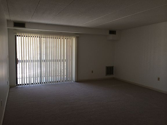Living/dining area with sliding glass door to balcony