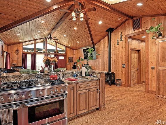 Kitchen.  Double oven with gas burners & grill, prep sink and eating bar. Kitchen area opens to living area. New LOPI natural gas free standing programmable stove in living room.  Beautiful vaulted ceilings and ceiling fans.