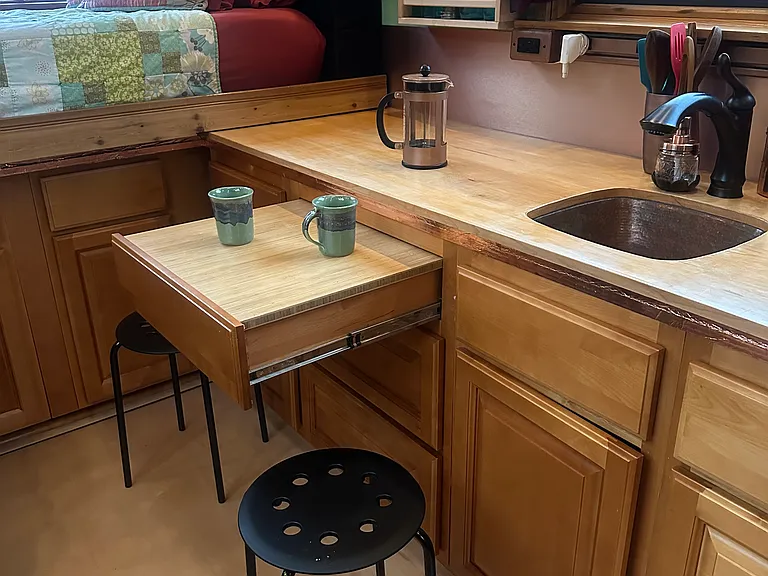 A tabletop can be added to the drawer and the stools pulled round to create a table for two for a meal or a cuppa!