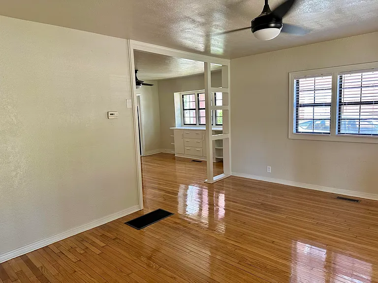 Living room, just inside front door and looking into dining room area